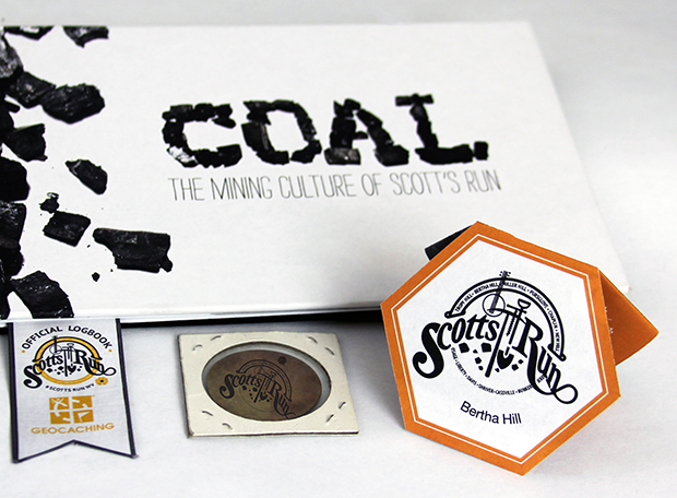 Inside Geocache for Scott's Run that includes a log book, instructions and a takeaway coin