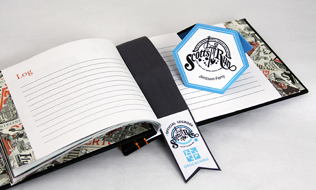 Inside Geocache for Scott's Run that includes a log book, instructions and a honeycomb booklet